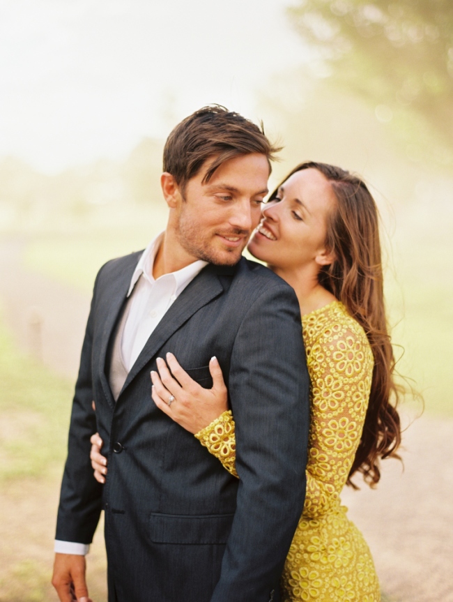 girl in yellow dress embracing man in grey suit