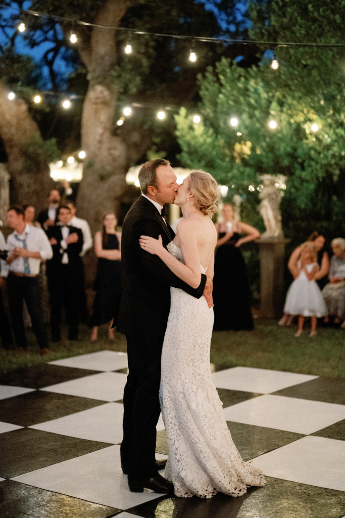 Bride and groom dancing on checkered outdoor dance floor Austin wedding garden reception