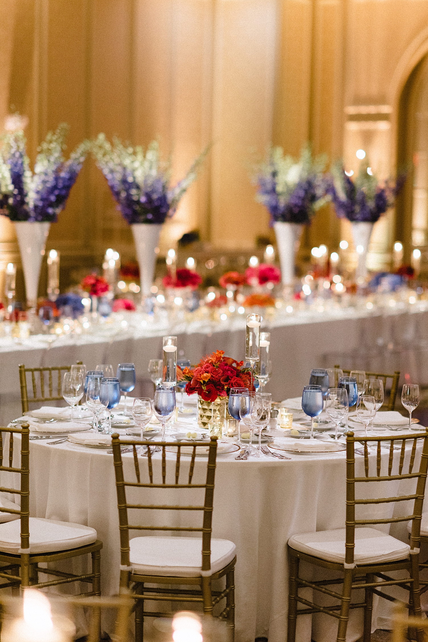 wedding reception table blue and red flowers ballroom