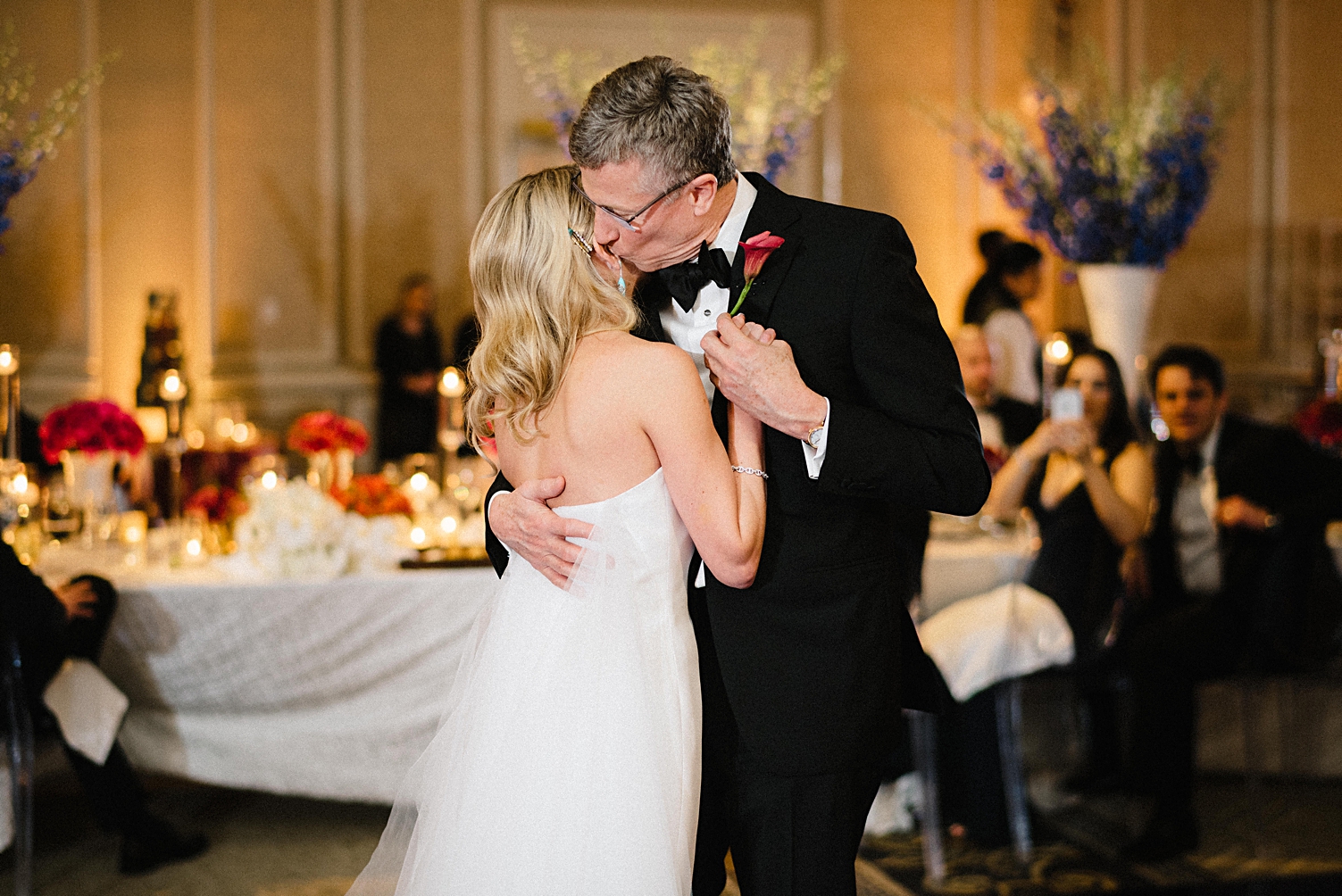 bride dancing with father at wedding reception kiss