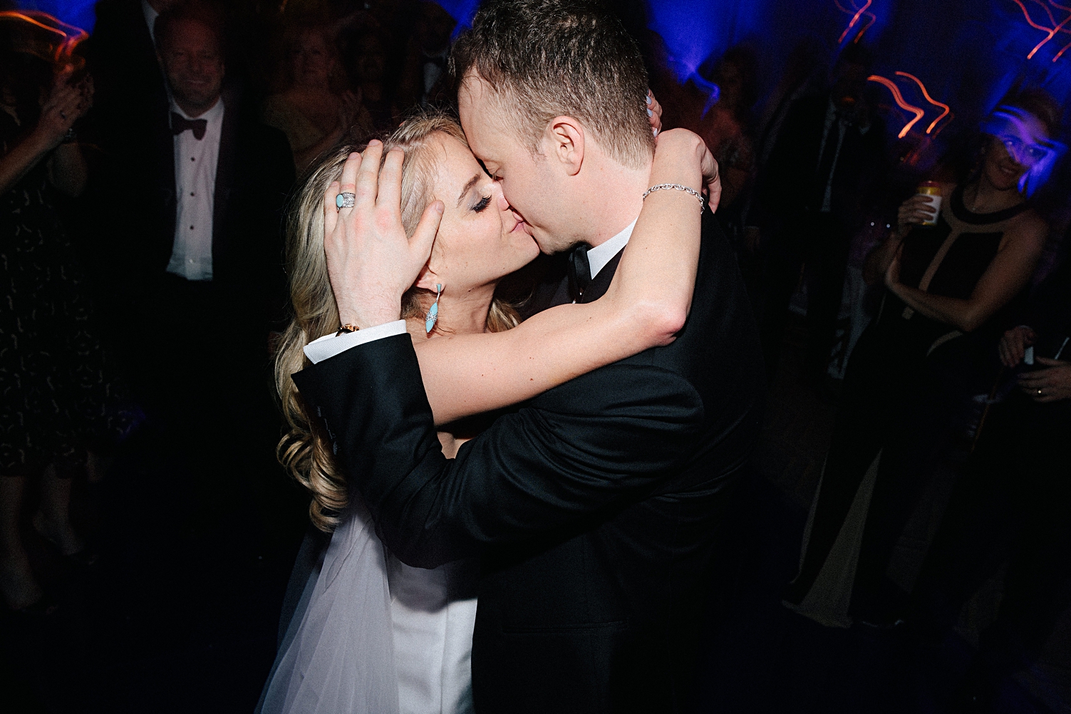 bride and groom kissing at wedding reception party