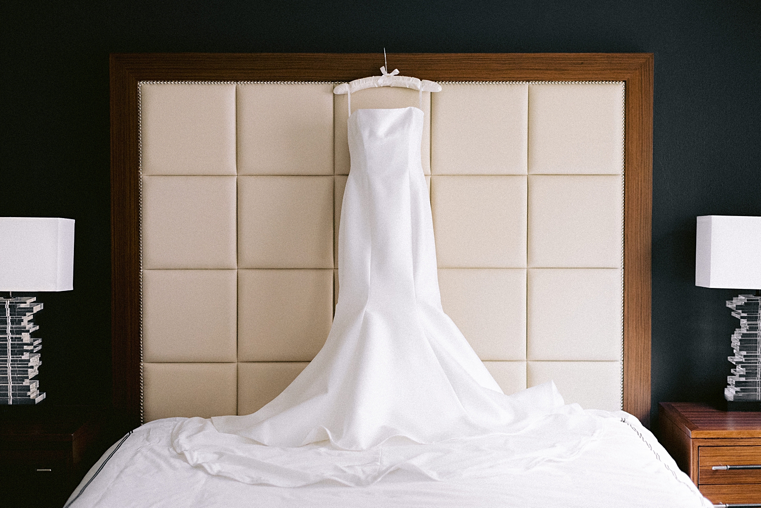 Adolphus Hotel Wedding Dress hanging on bed