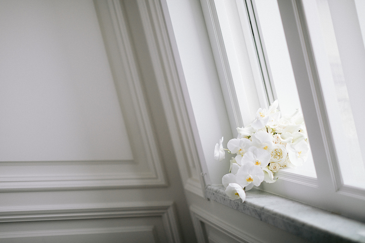 white orchid bouquet on window