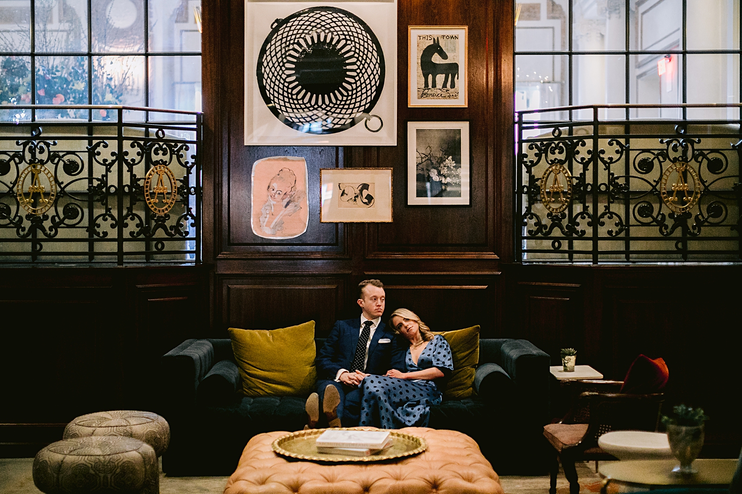 couple sitting in the adolphus hotel under art