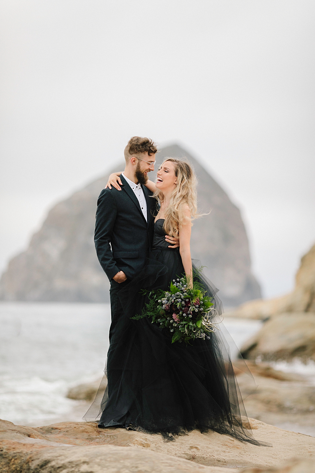 couple in black oregon beach elopement