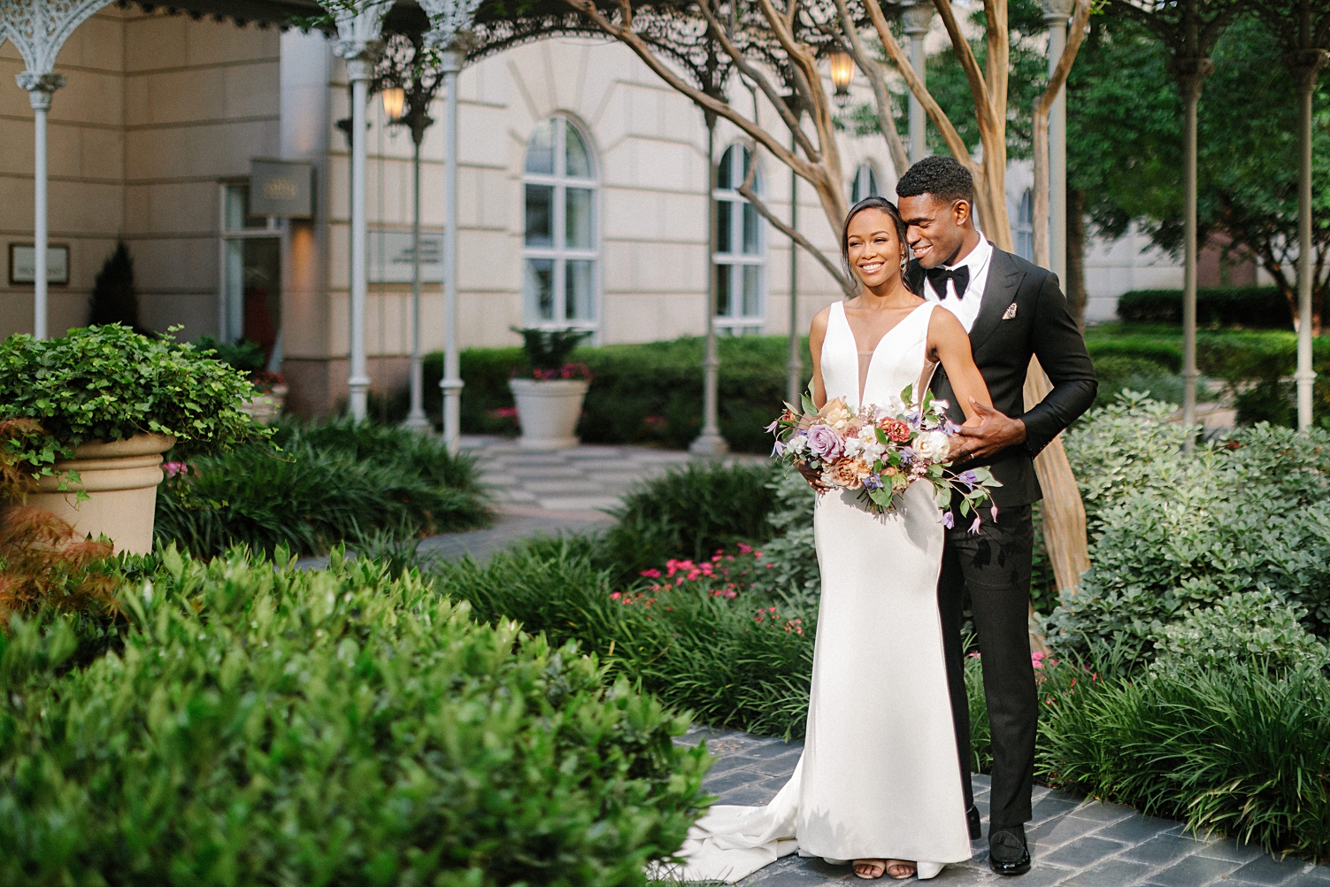 Hotel crescent court dallas wedding couple standing in courtyard