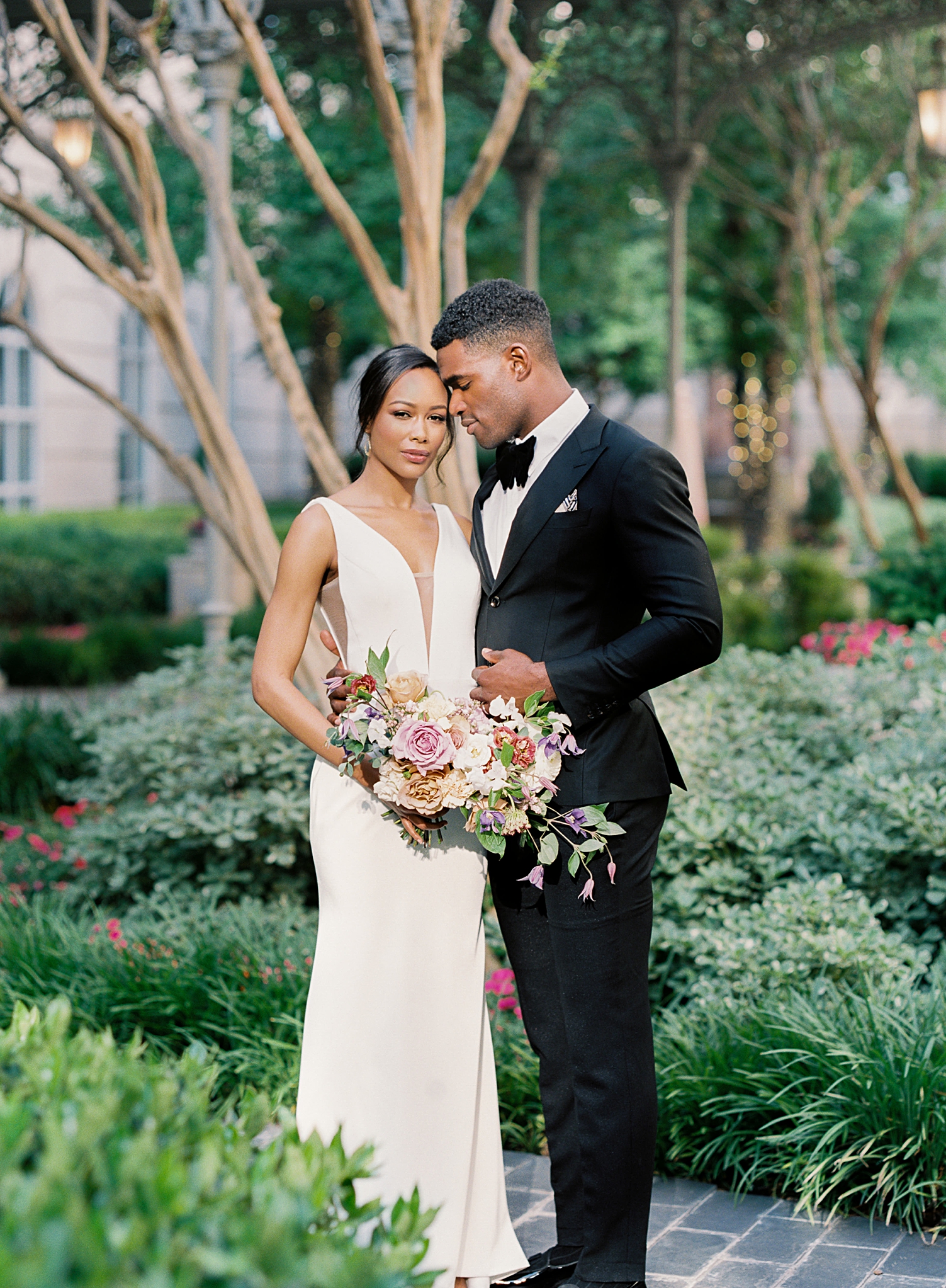 Hotel crescent court dallas wedding couple standing in courtyard on film