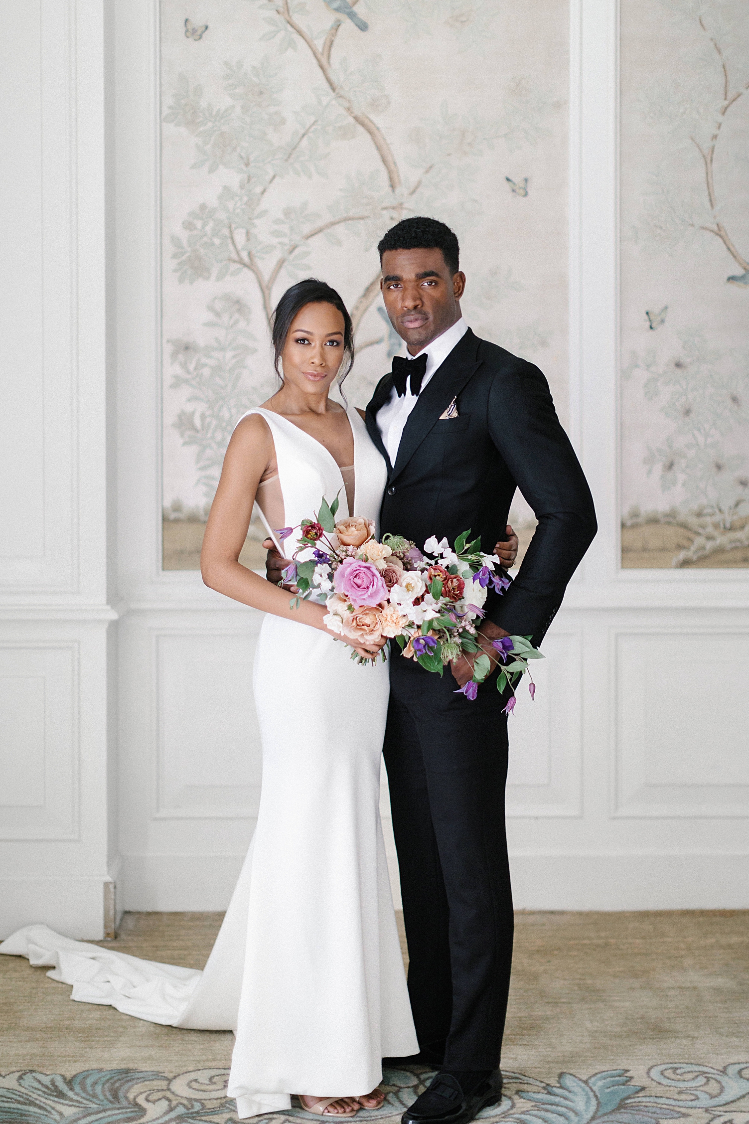 elegant African American bride and groom with bouquet