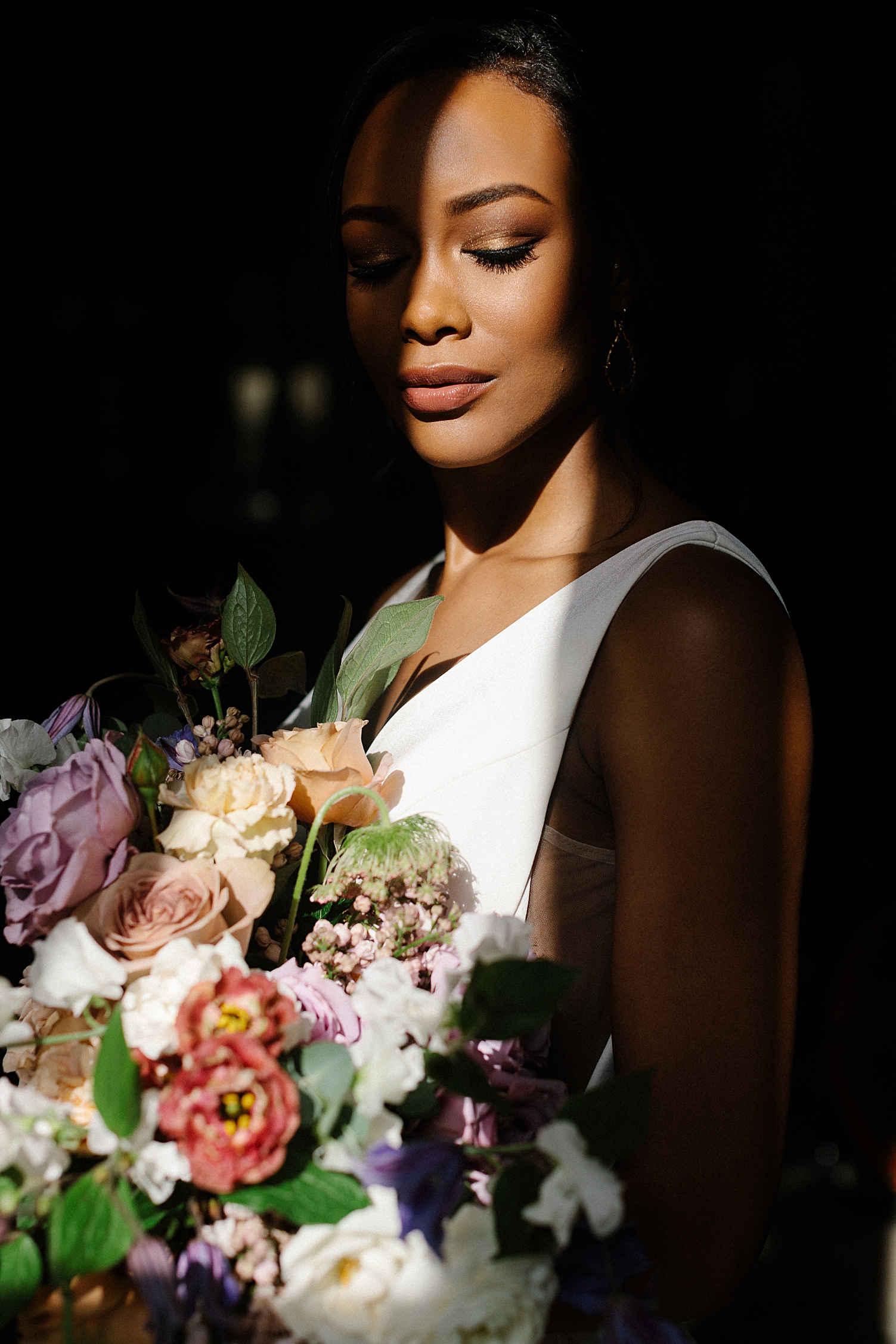  bride with bouquet in window light