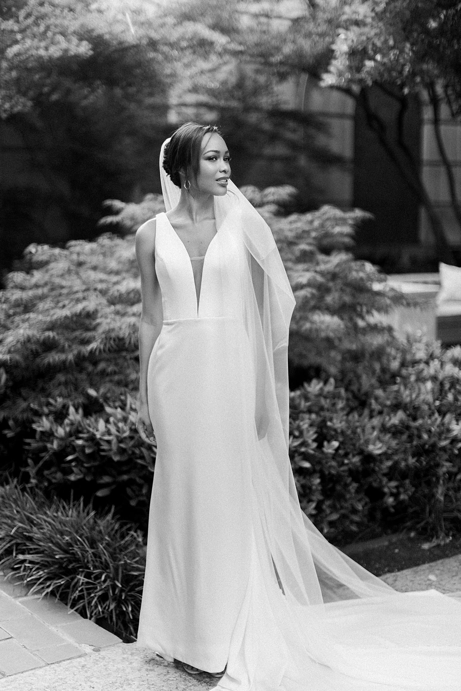 black and white bride in wedding dress standing in garden
