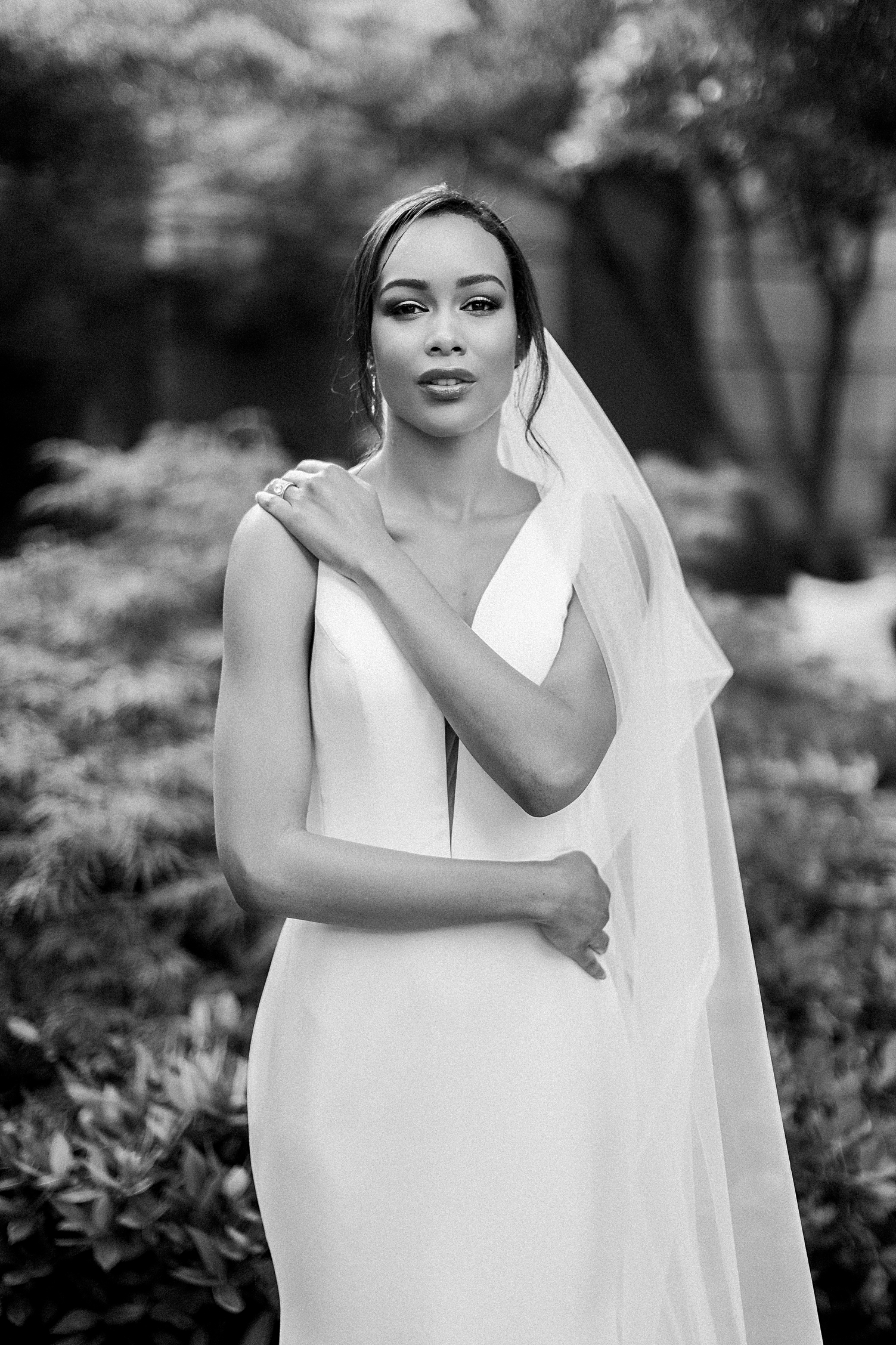 black and white bride with arms crossed in dress and veil at crescent hotel wedding