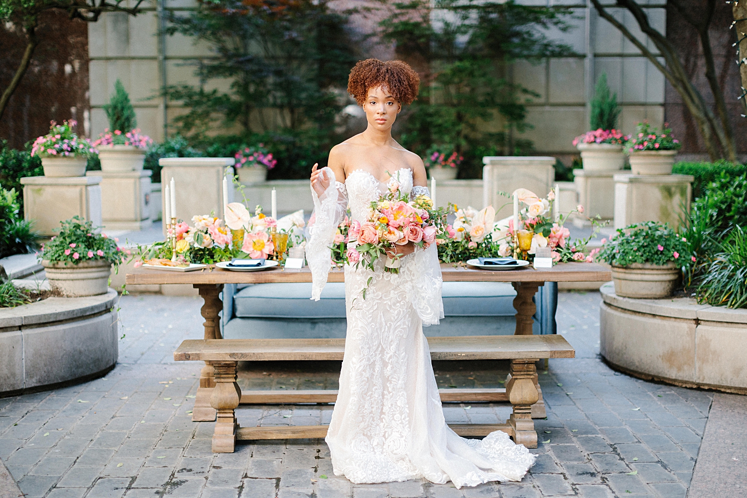 Bride in lace boho wedding dress and pink bouquet at crescent hotel wedding