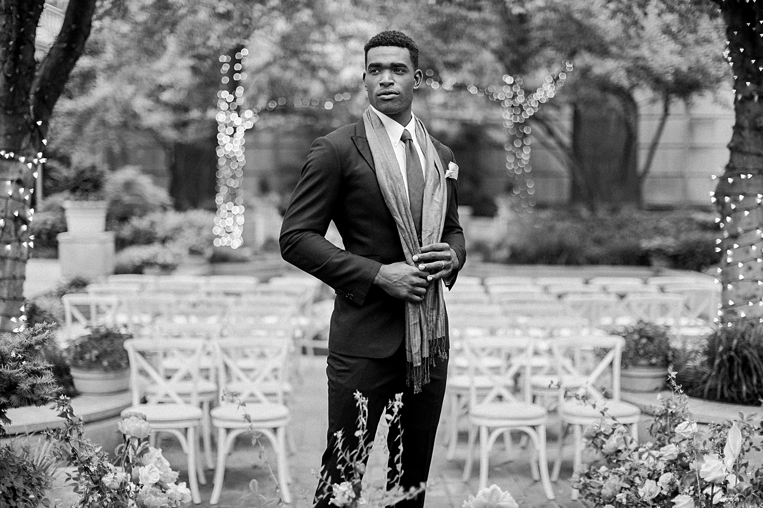 black and white groom standing in front of garden ceremony site crescent hotel wedding