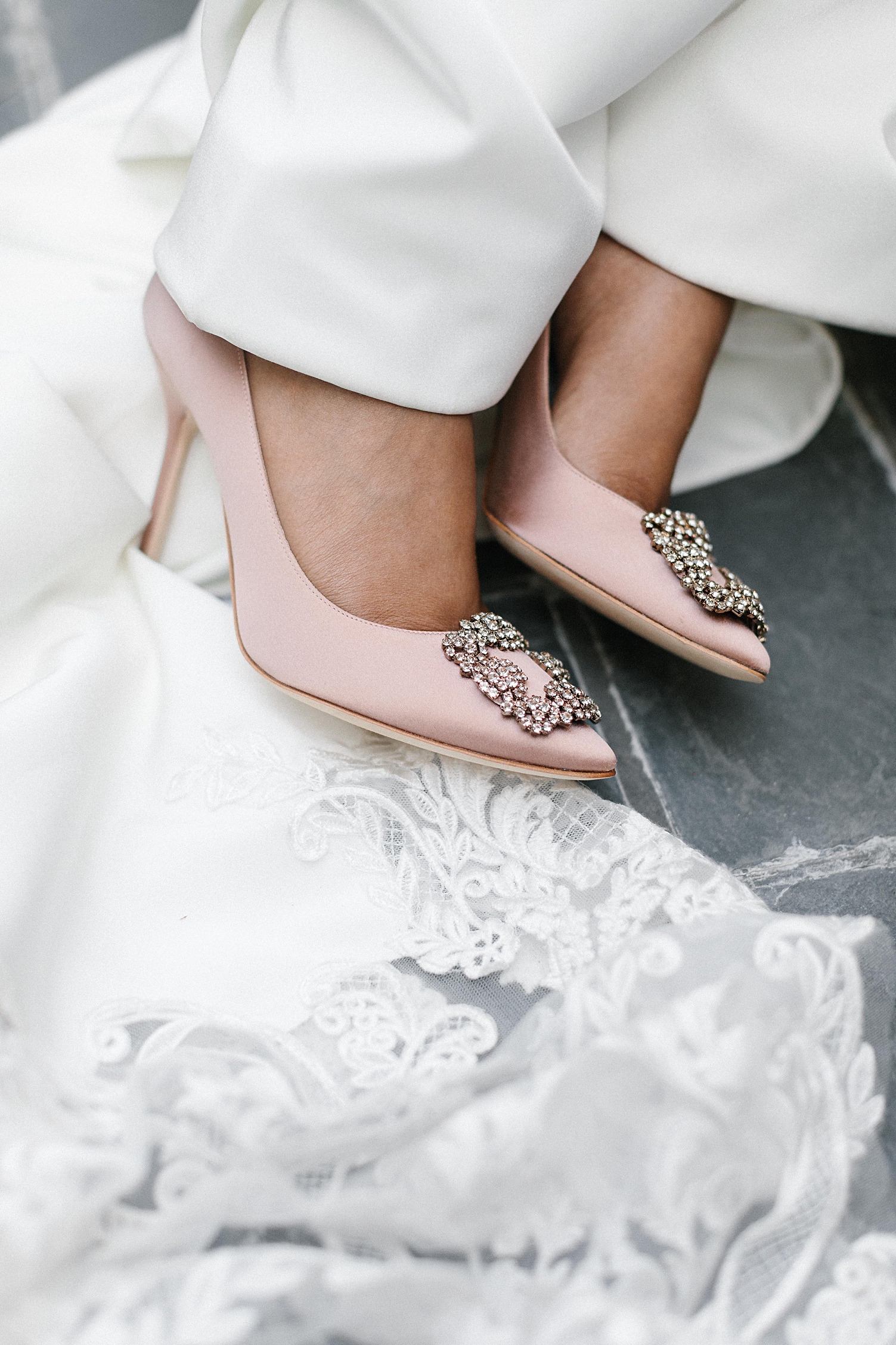 Pink high heels on brides feet