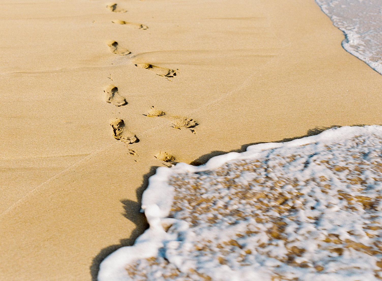 footprints in sand on Maui beach elopement