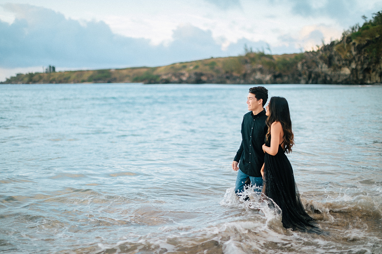 Couple in black in beach water Maui hawaii