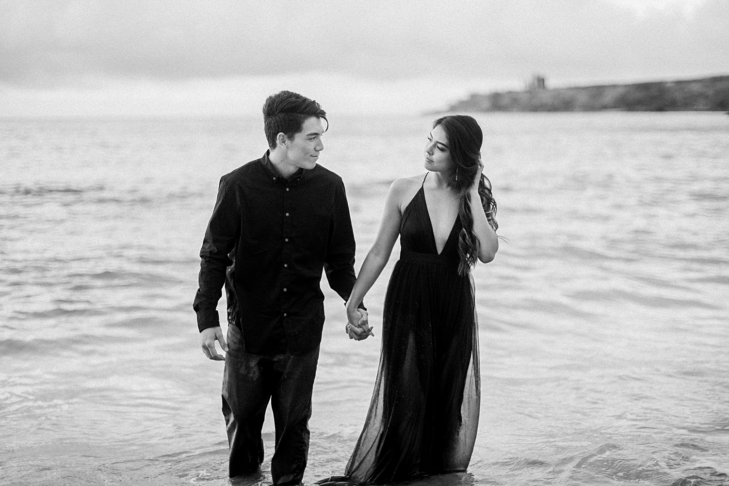 Couple in black in ocean water hawaii black and white