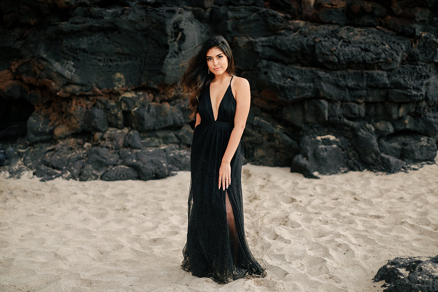 Hawaiian girl in black tulle dress rocky beach
