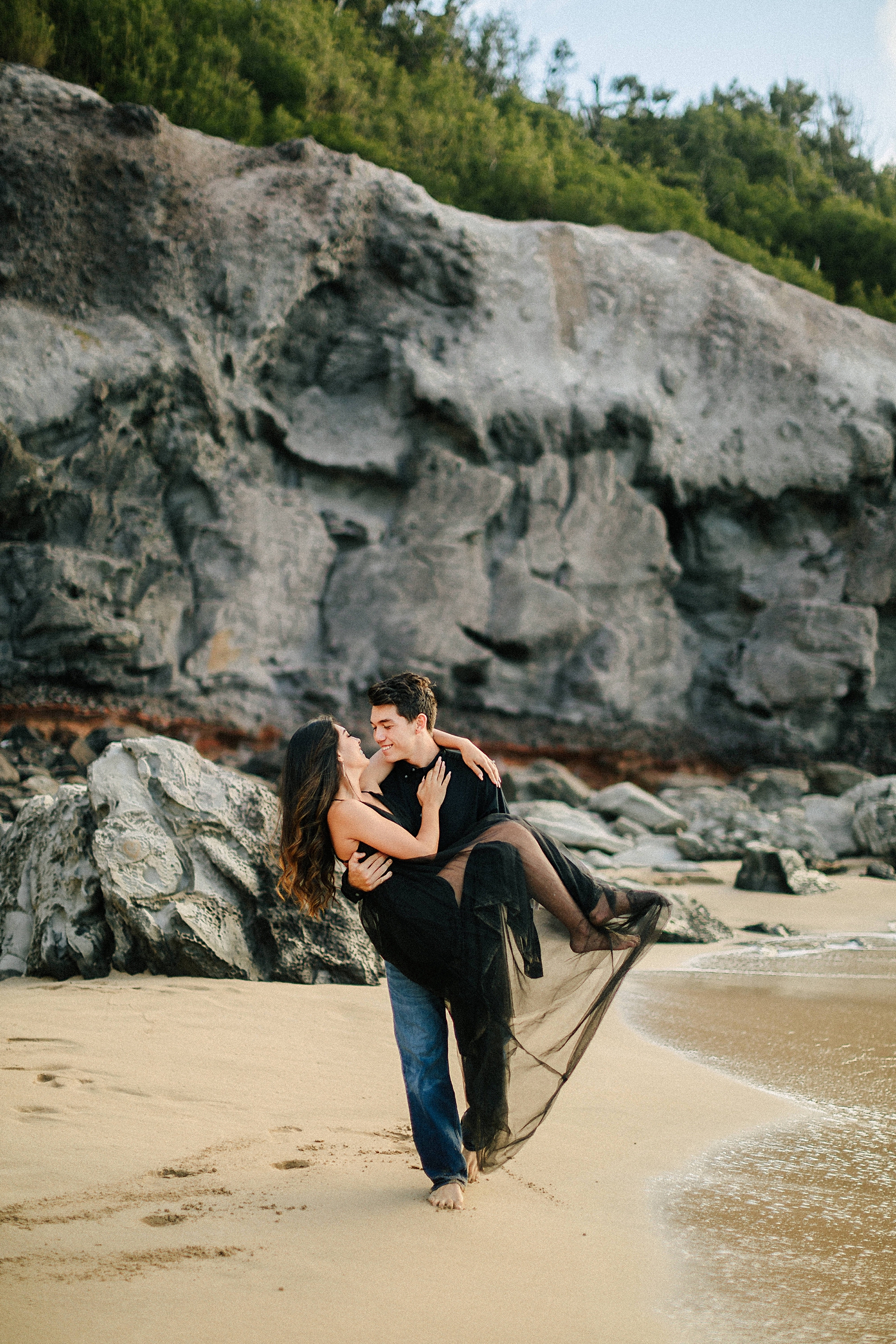 Maui beach elopement black dress groom carrying bride