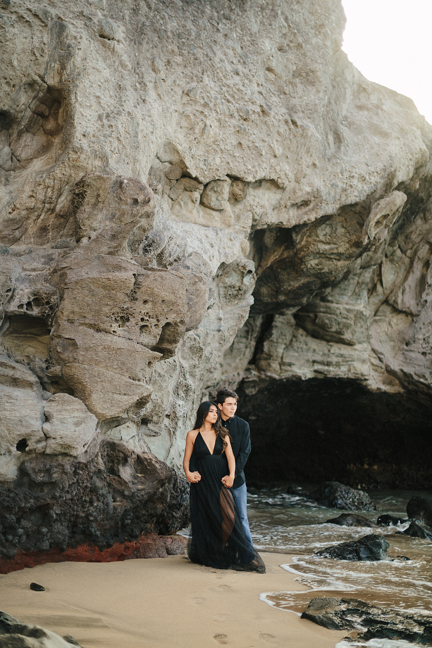 Oahu engagement couple in black on slaughterhouse beach
