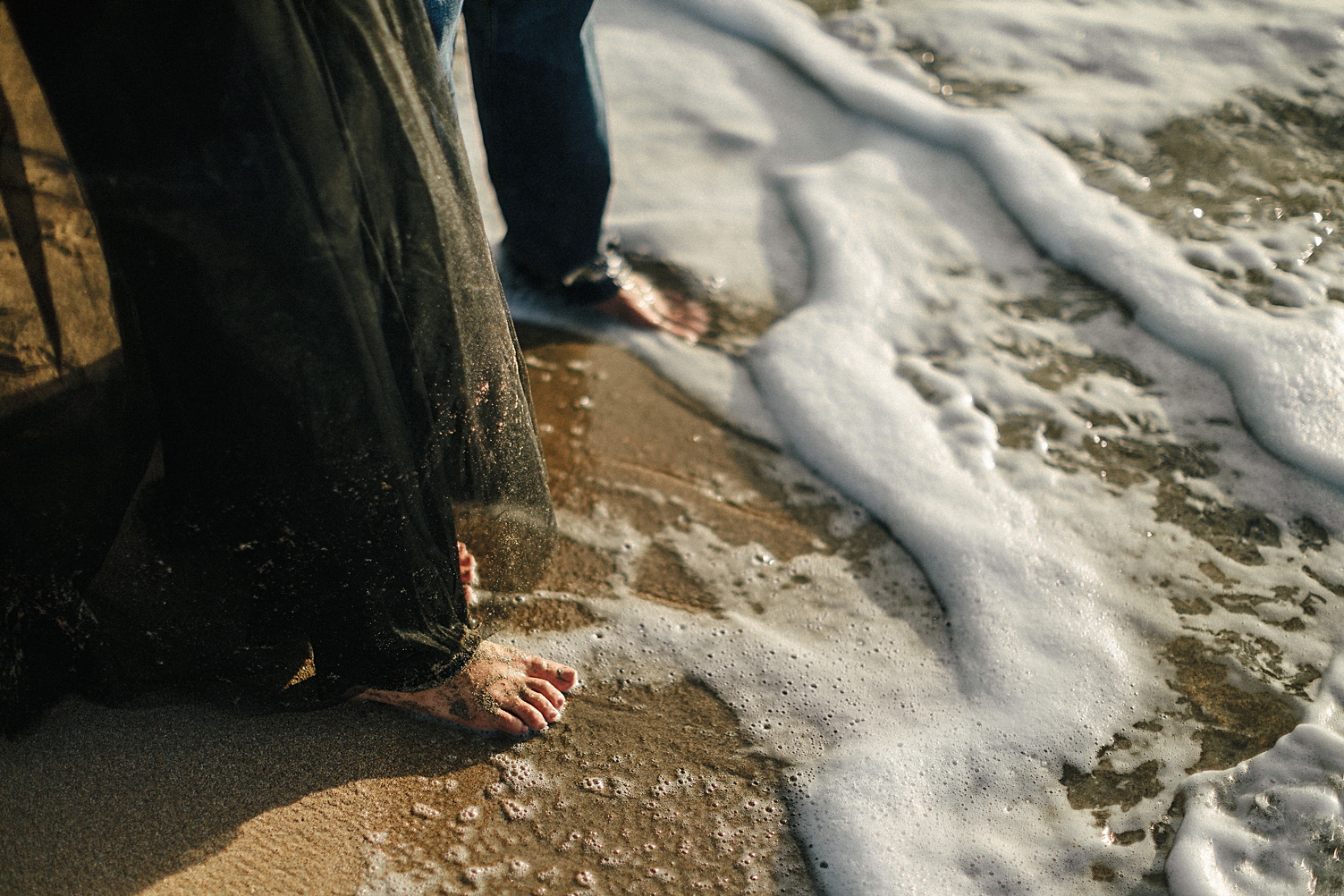 tropical beach engagement session couple feet in water