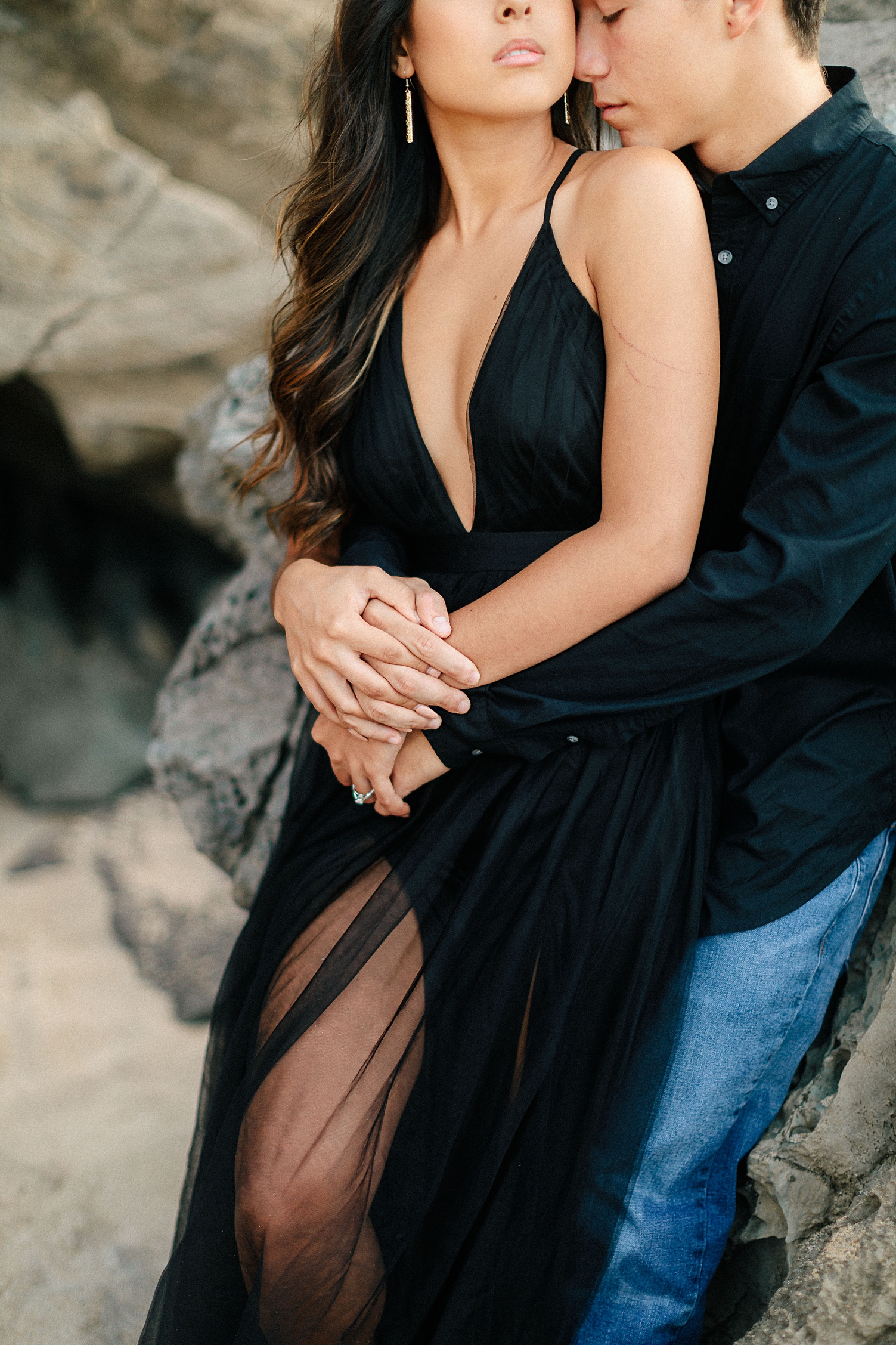 couple on beach holding hands black tule dress