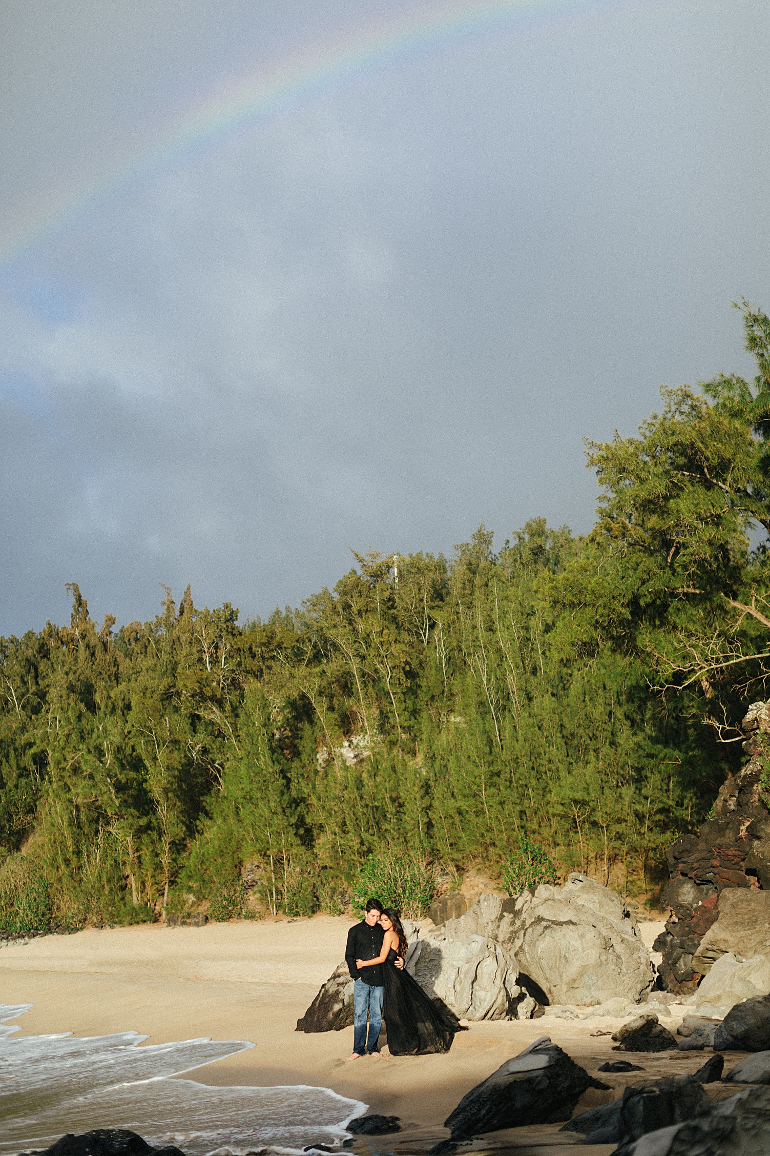 Hawaii engagement couple on beach rainbow 