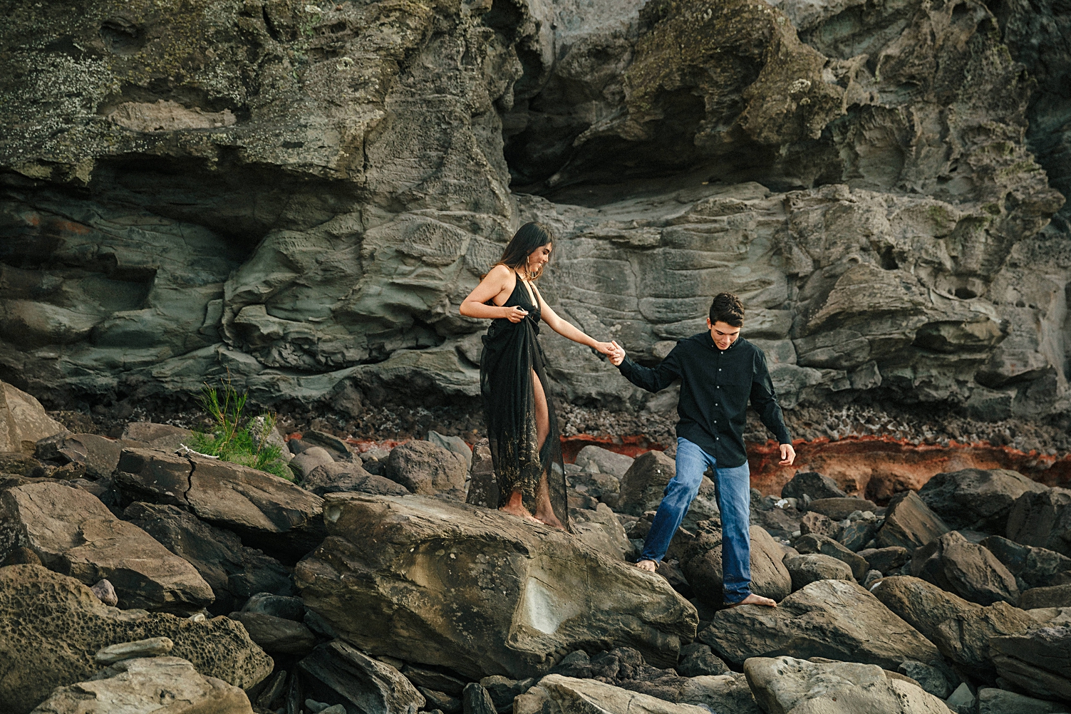 Maui engagement standing on beach rocks destination wedding