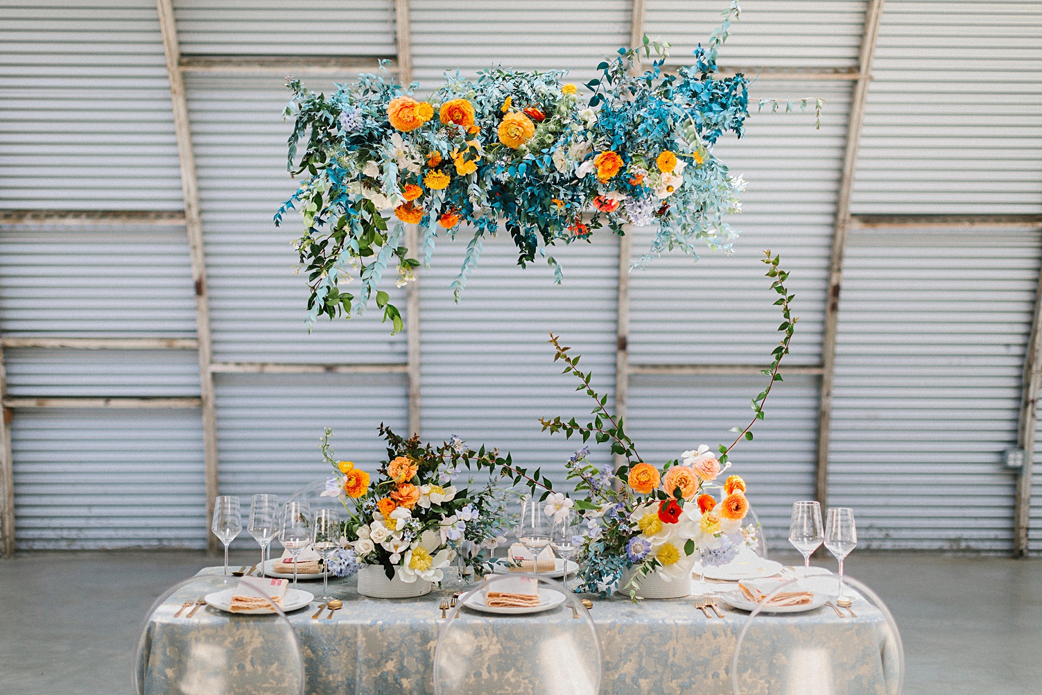 Fort Worth Florist Tersilla Studio blue orange flowers table instillation