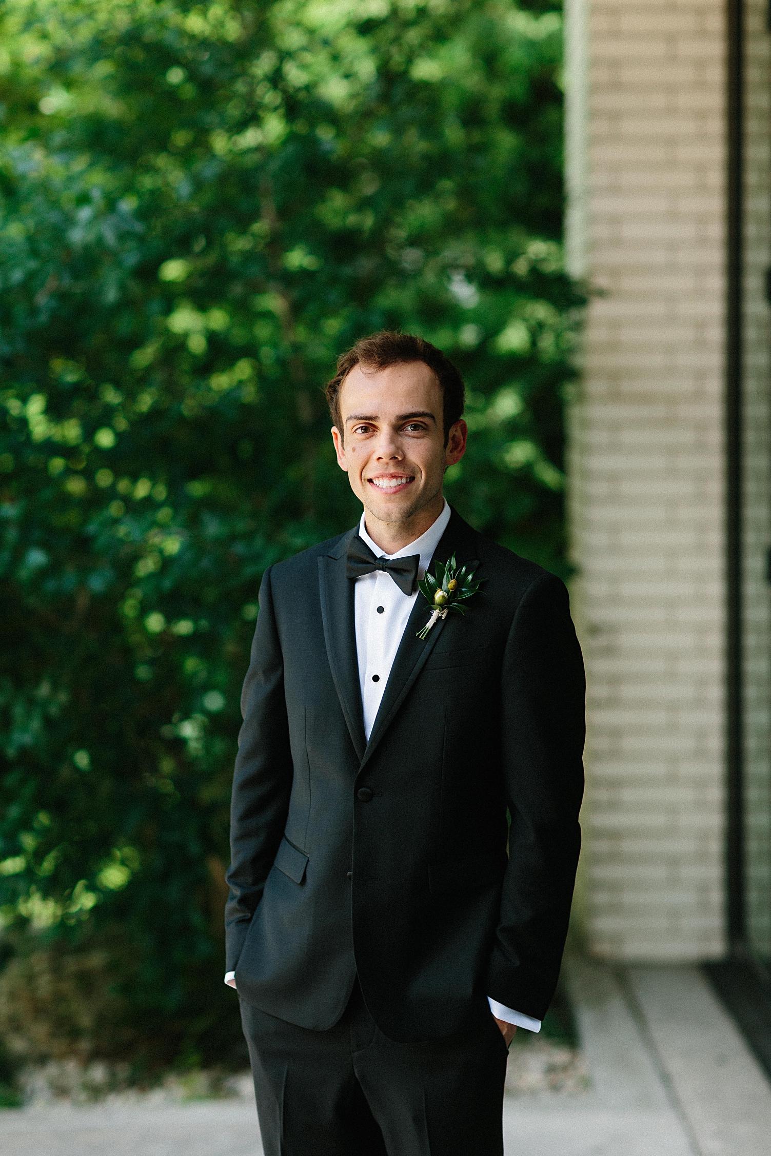 Groom in tuxedo at South Congress Hotel Austin bow tie smiling