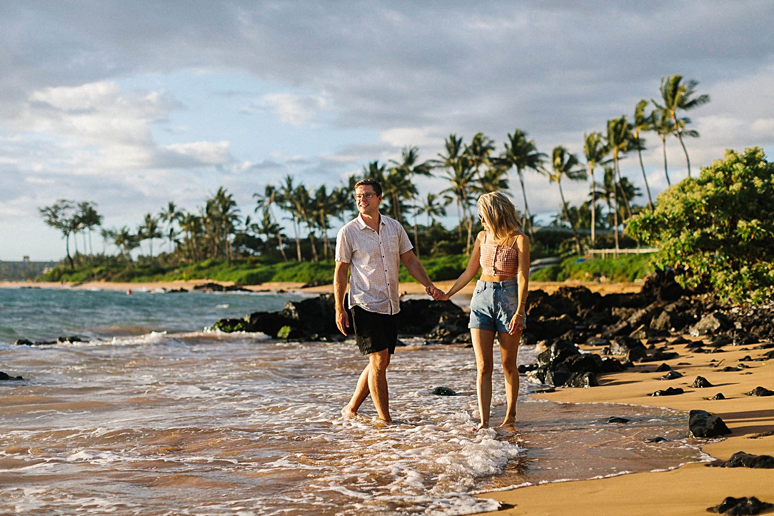 couple holding hands on beach in Maui Hawaii