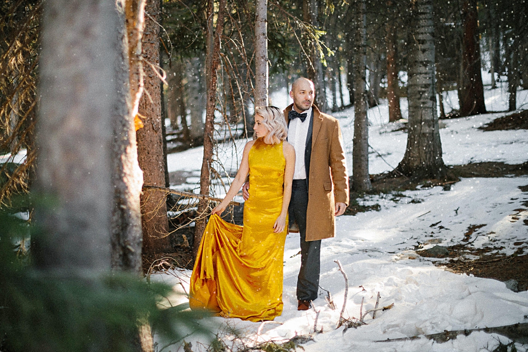colorado rocky mountain woods couple gold dress winter snow