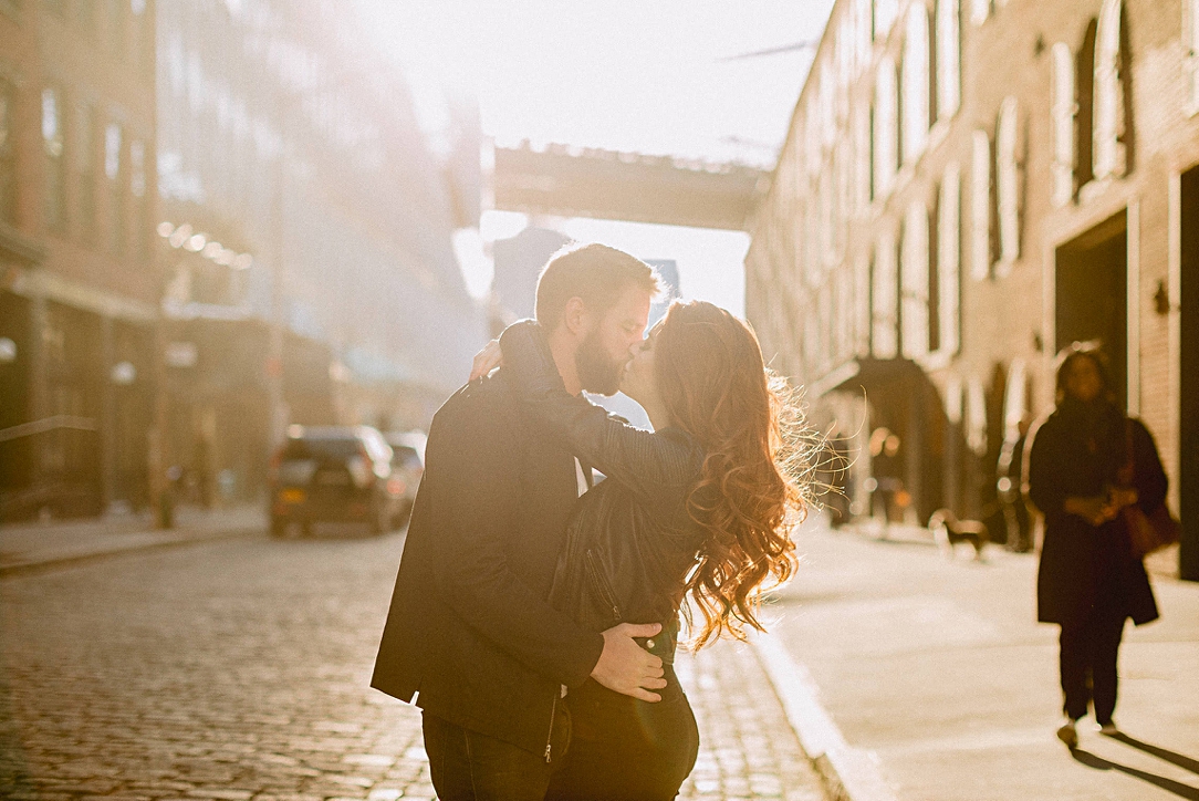 Couple kissing on NYC street sunset