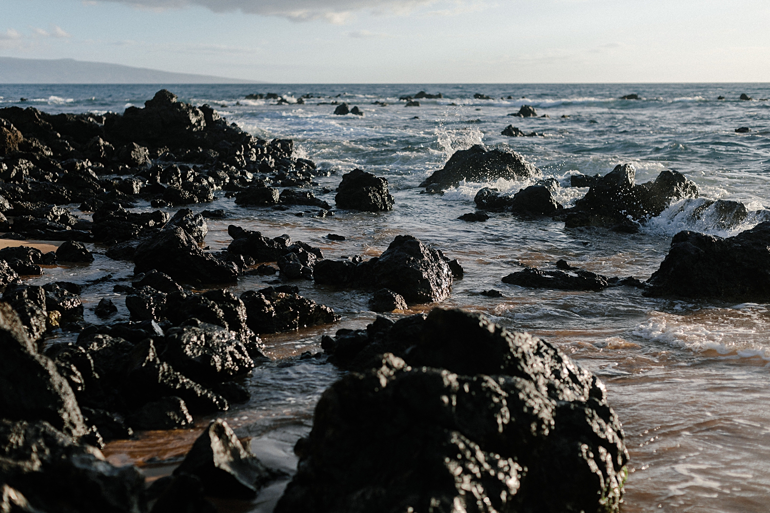 black rocks on hawaii beach
