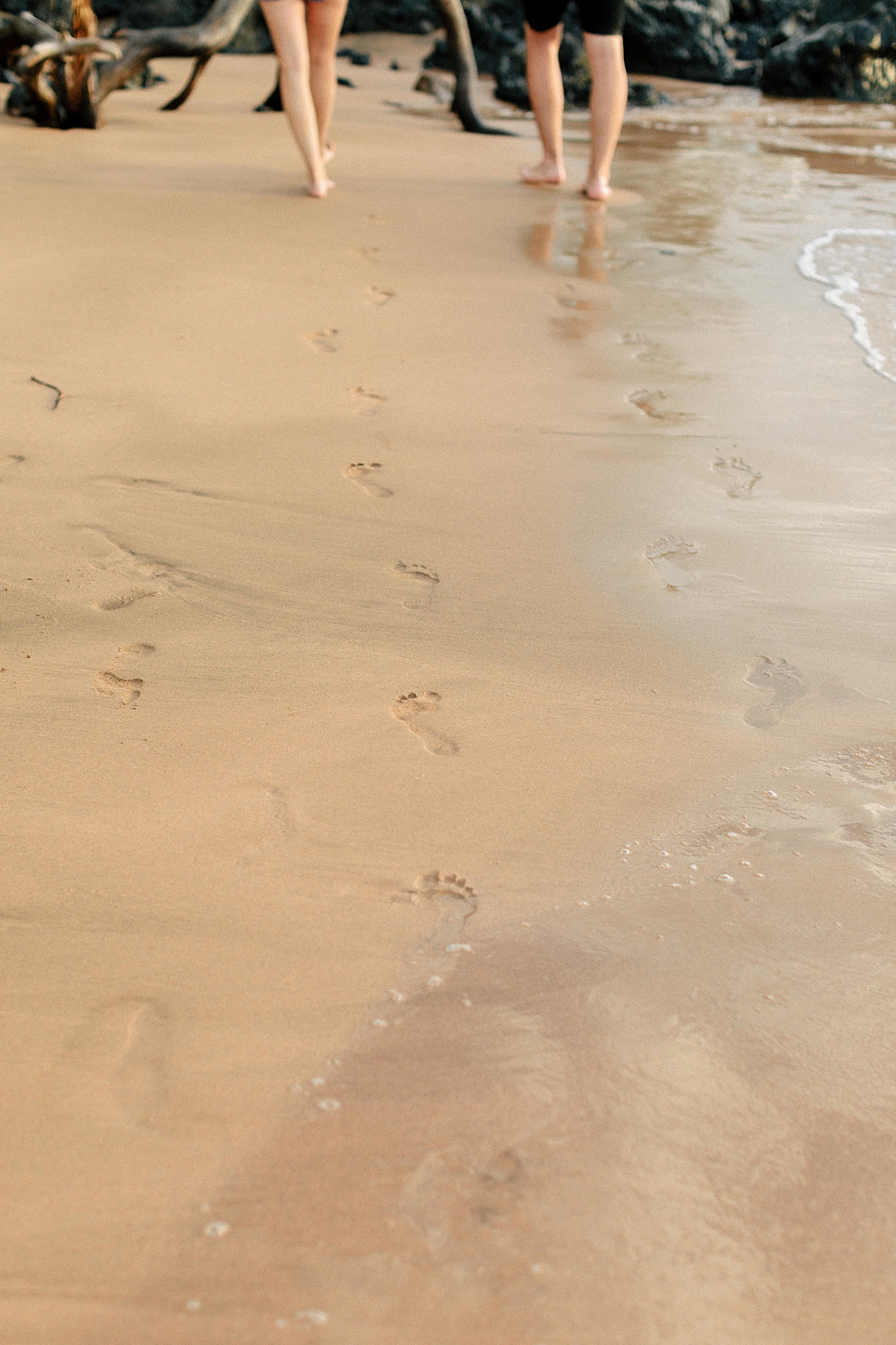 footprints on beach couple