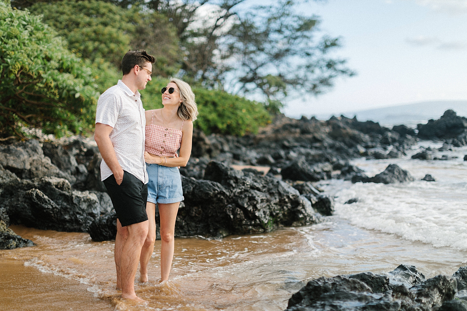 girl looking at man on hawaii beach
