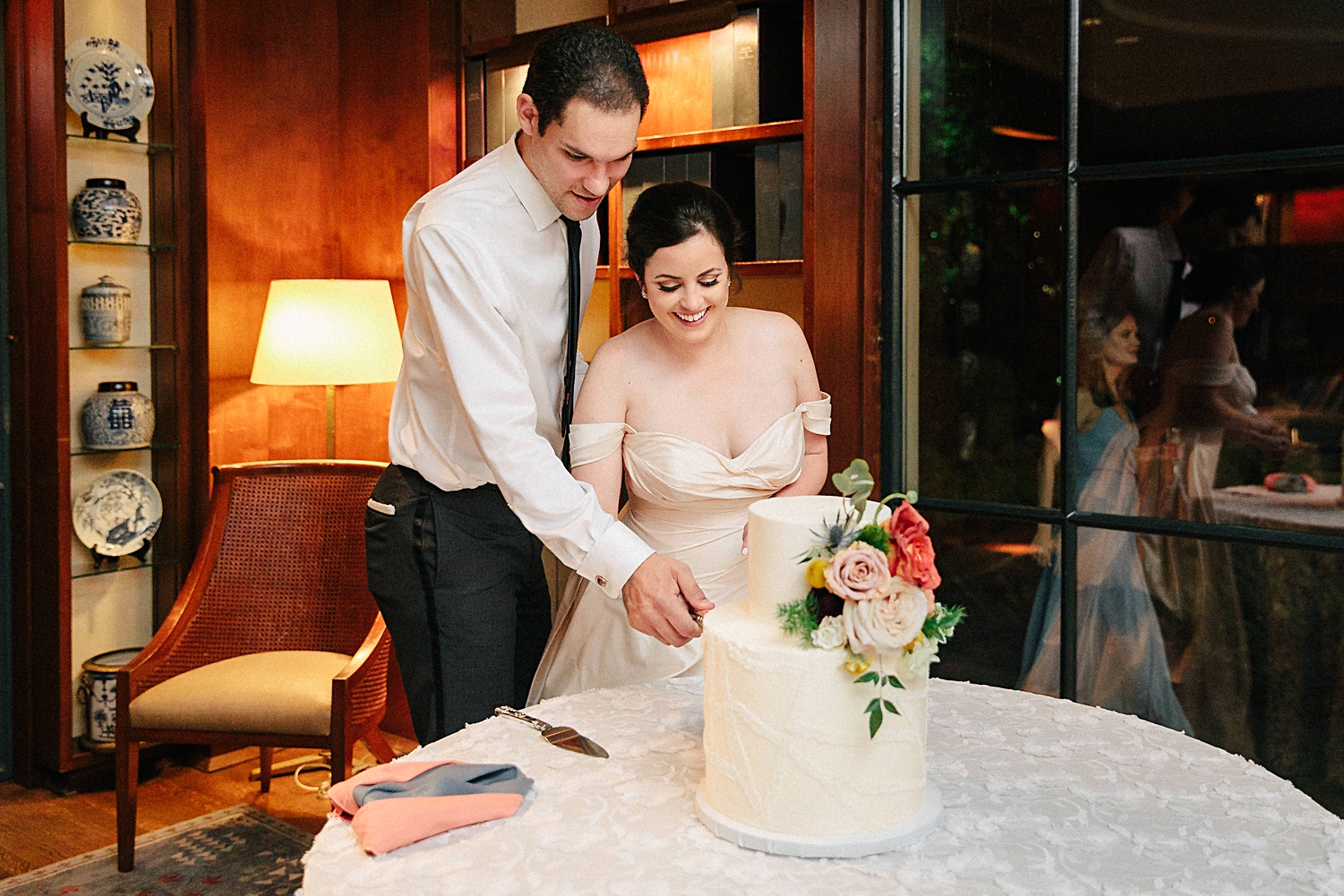 bride and groom cutting cake wedding reception