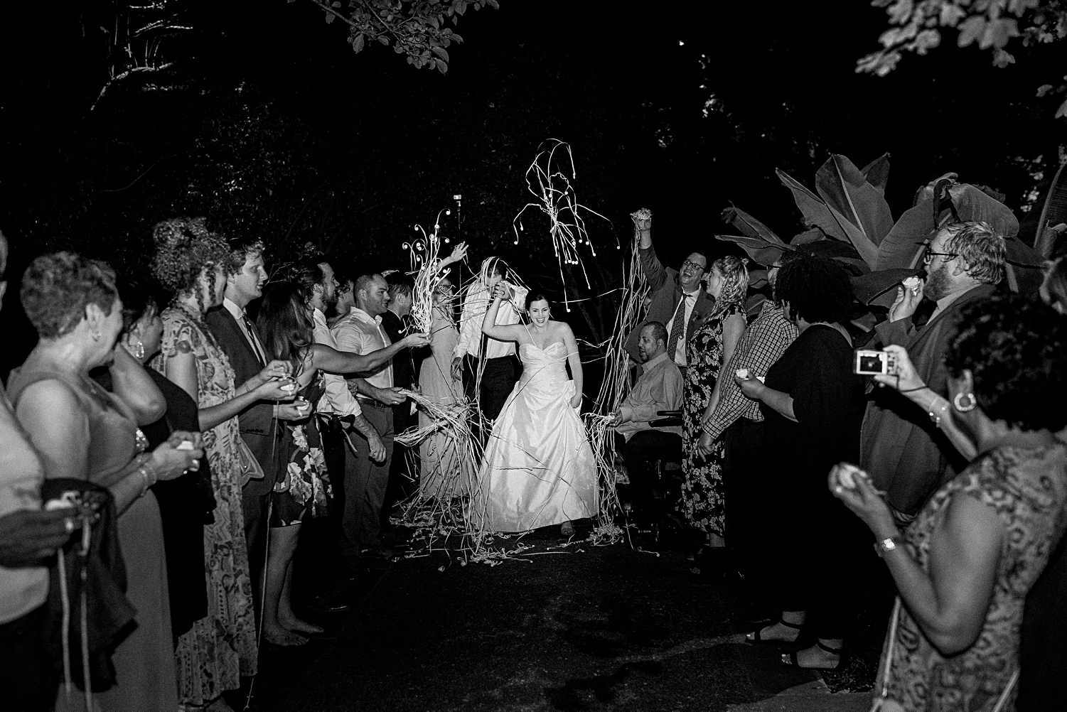 bride and groom exiting wedding reception at night