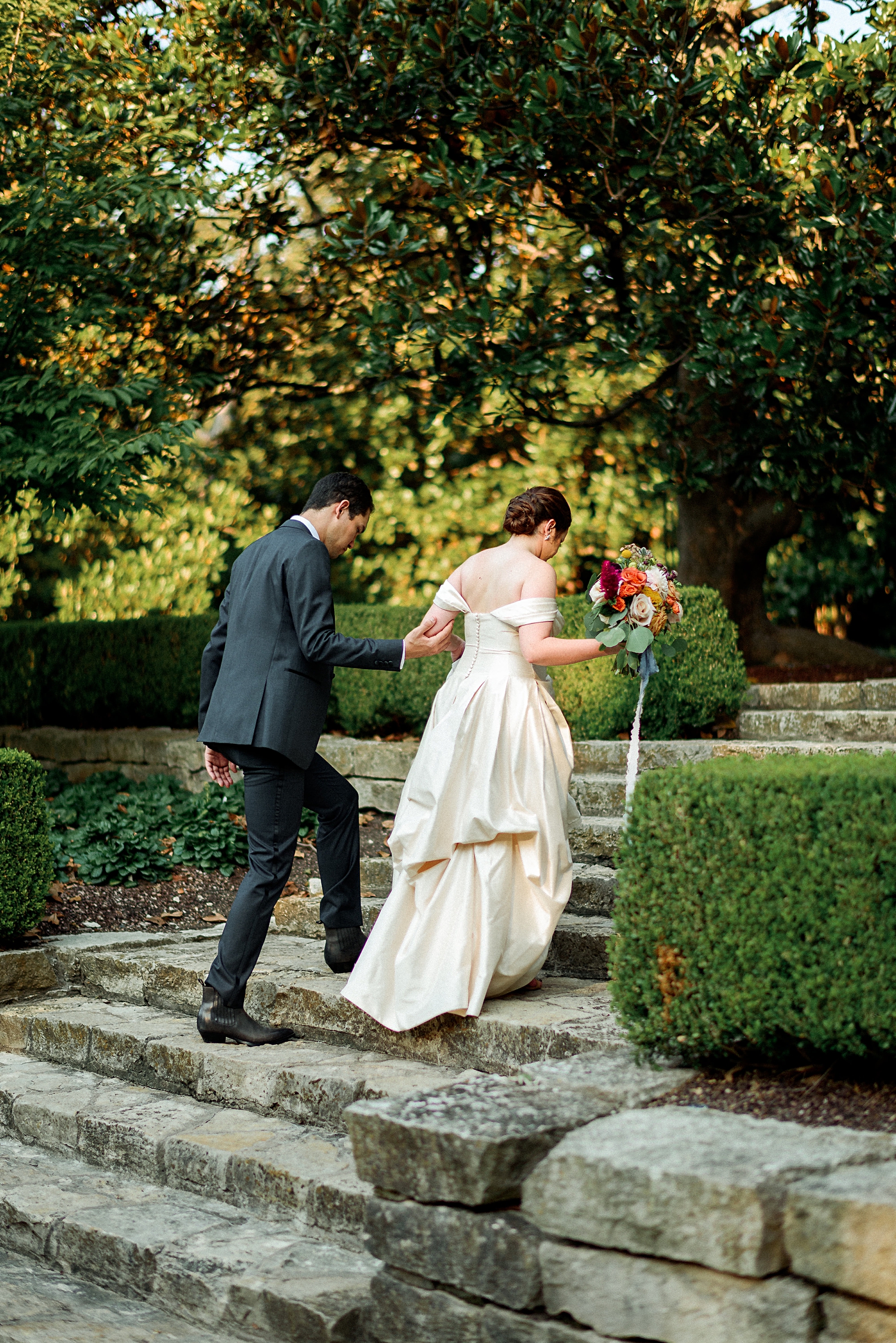 bride and groom walking up stairs Dallas arboretum wedding
