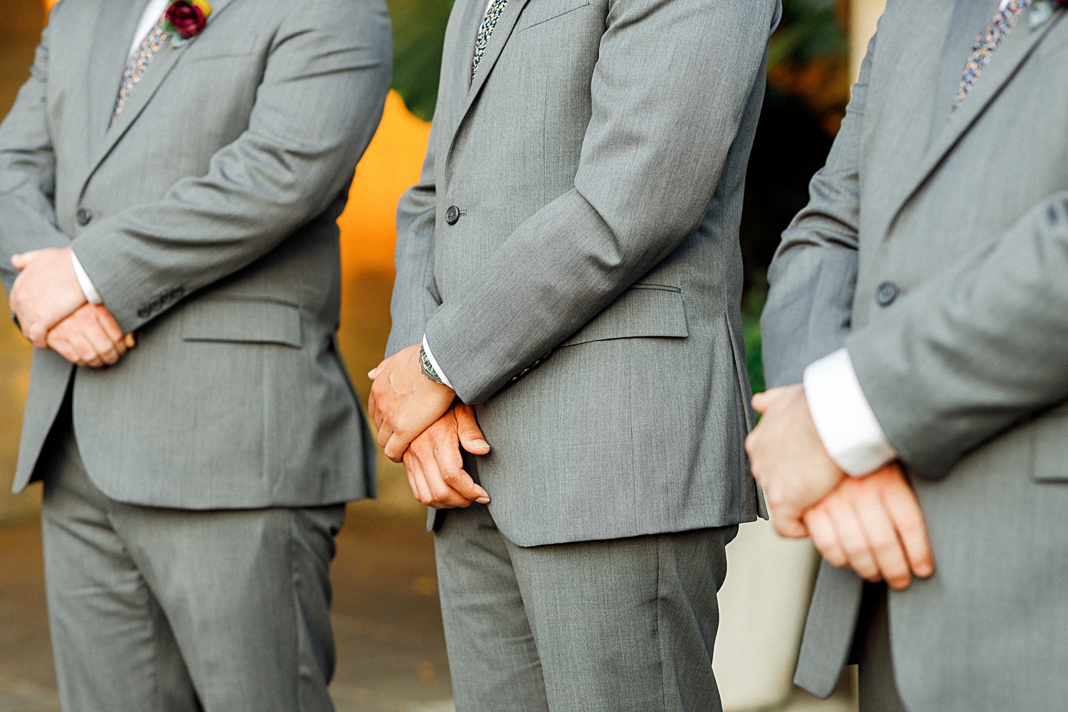 groomsmen standing at altar with hands crossed
