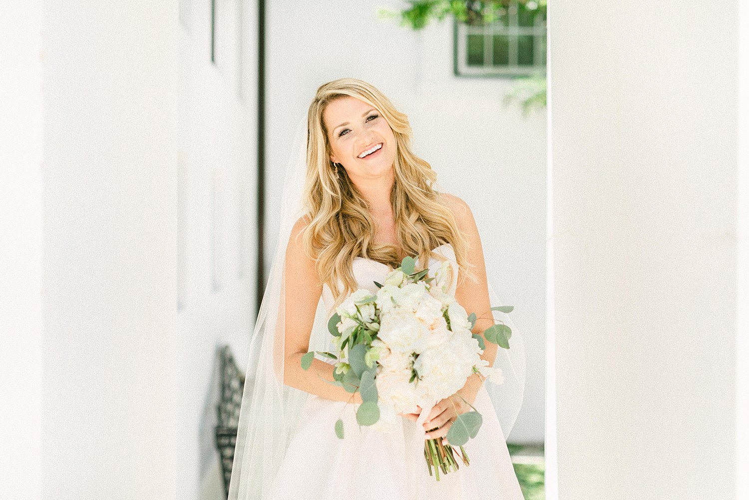 Bride in white dress doorway Alys Beach Florida