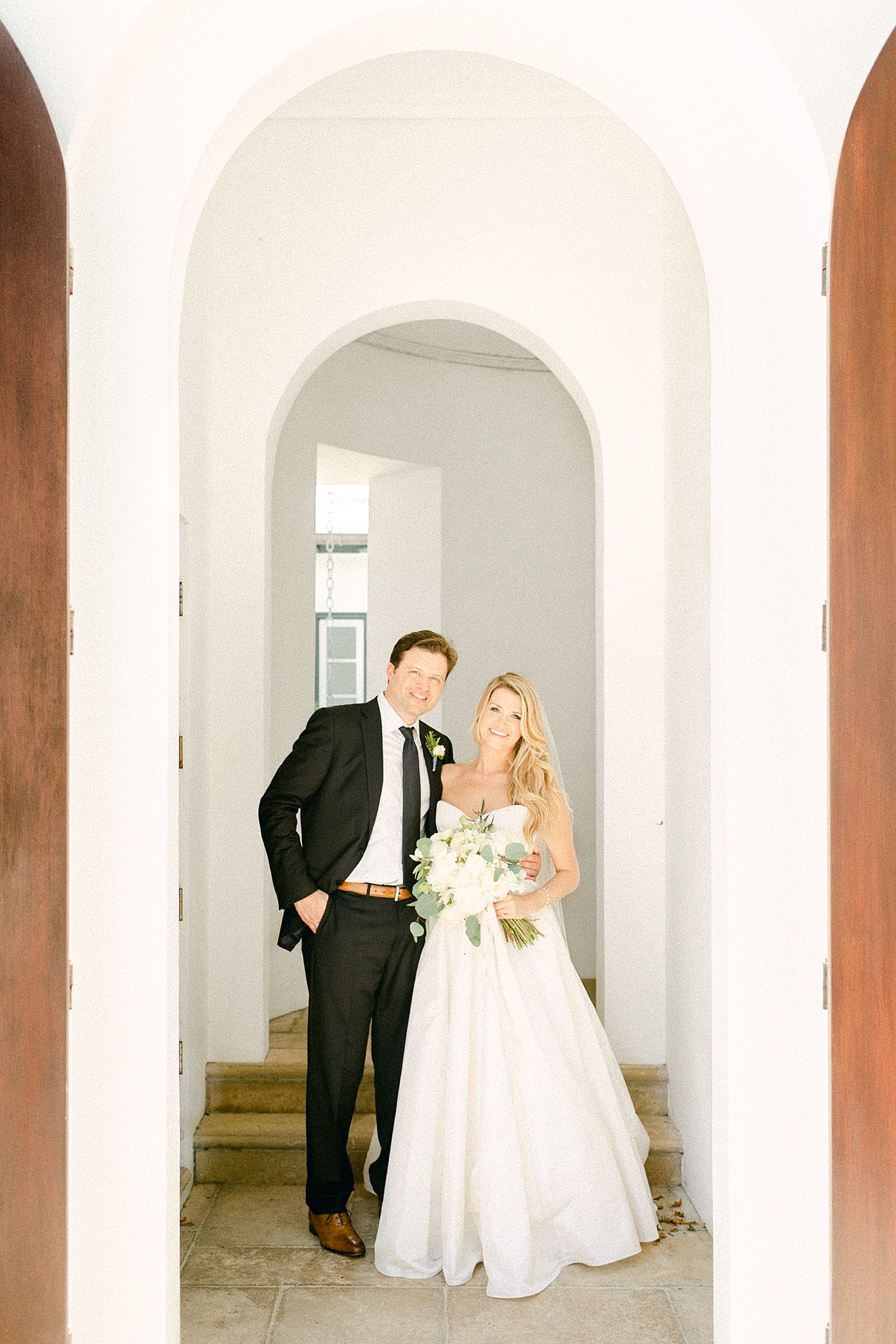 Bride and groom in white doorway Alys Beach Florida