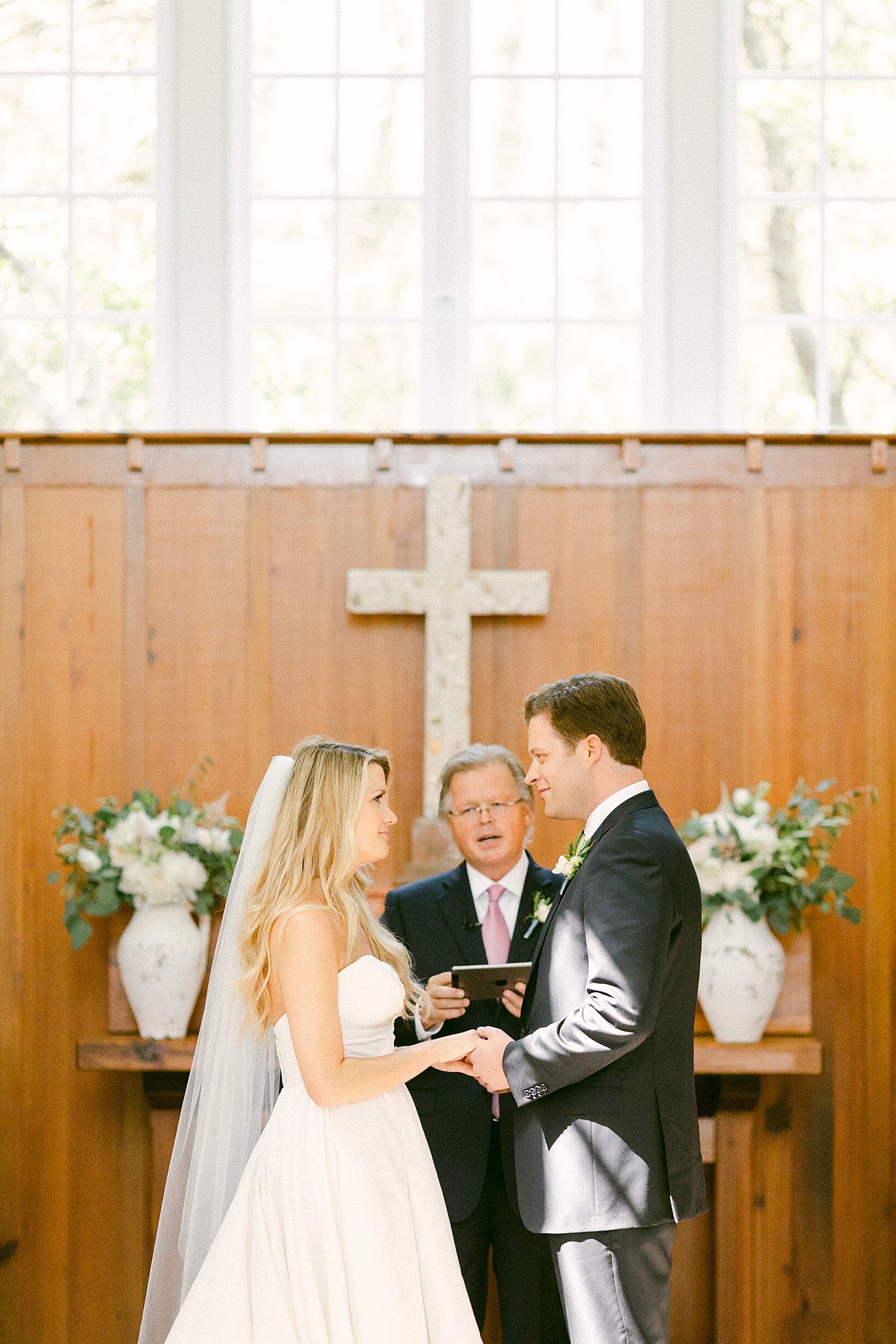 bride and groom holding hands at wedding altar Seaside chapel Florida