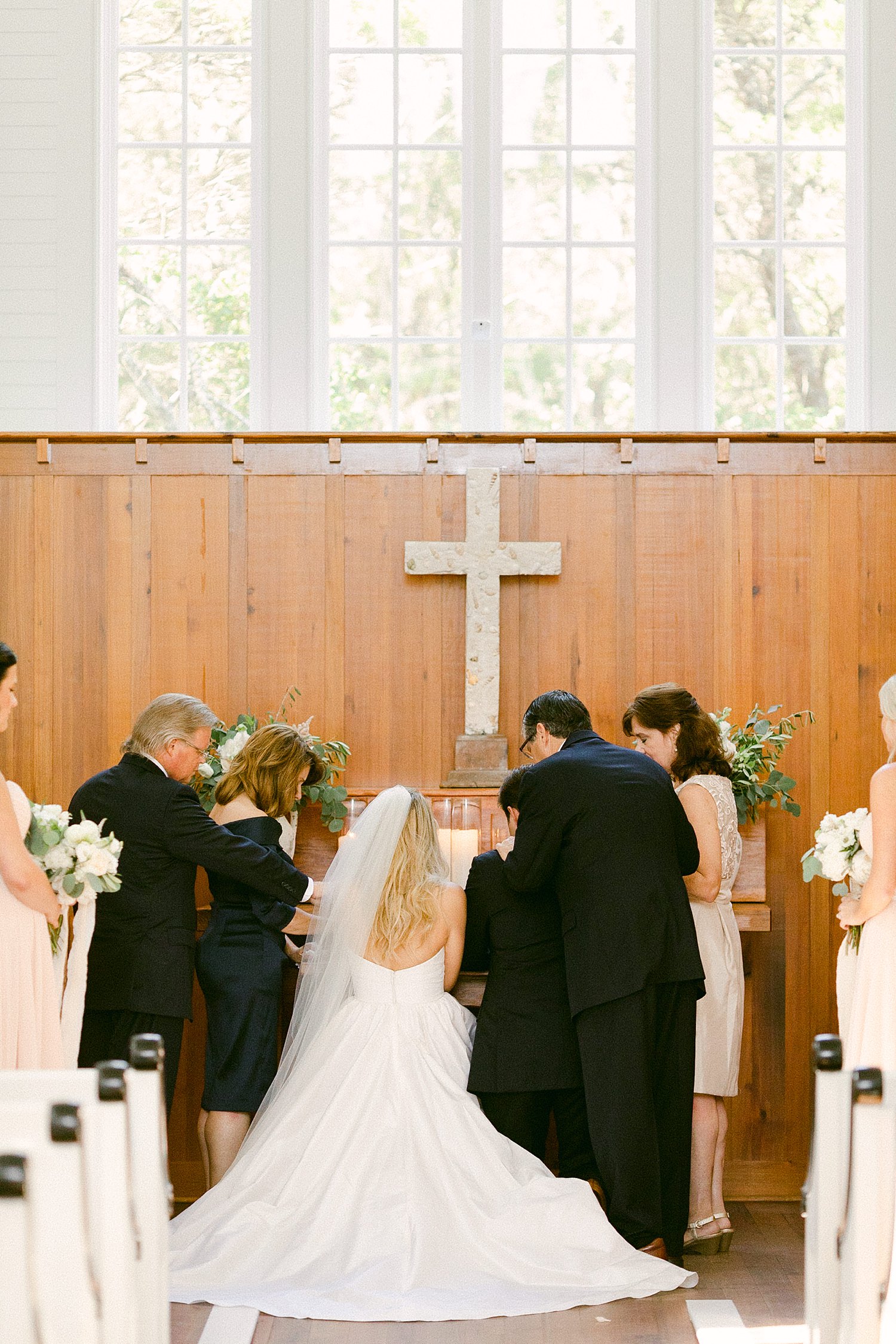 bride and groom kneeling at wedding altar Seaside chapel Florida