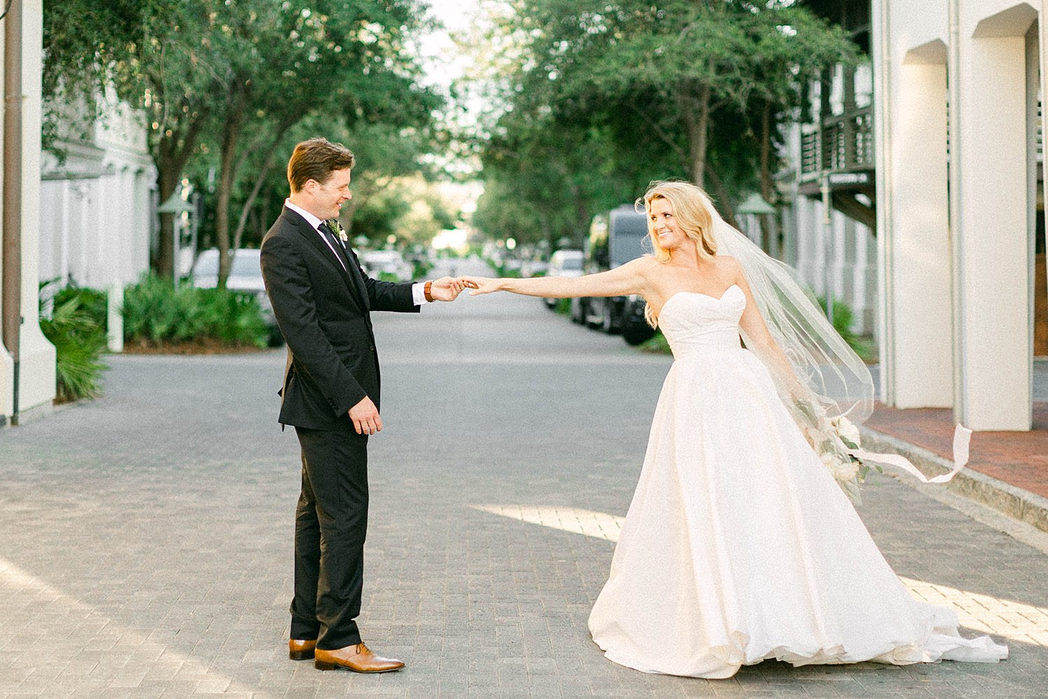 bride and groom spinning dancing in Rosemary Beach Florida street at Pearl Hotel Wedding
