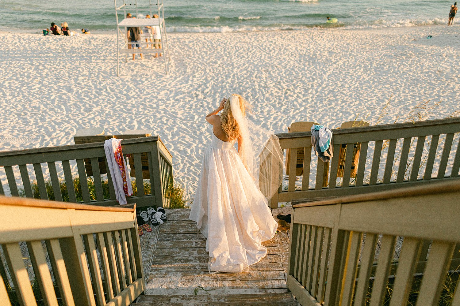 Bride walking down wooden entrance to rosemary beach wedding day at the Pearl Hotel in Florida