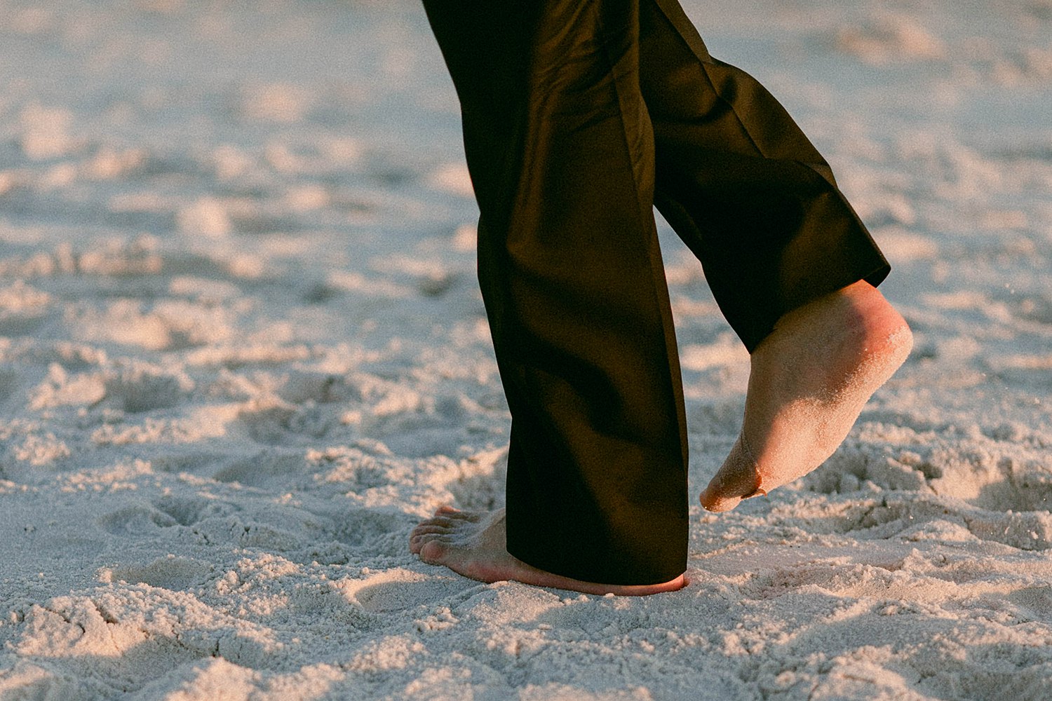 bare feet and black pants on beach at the Pearl Hotel in Rosemary Florida
