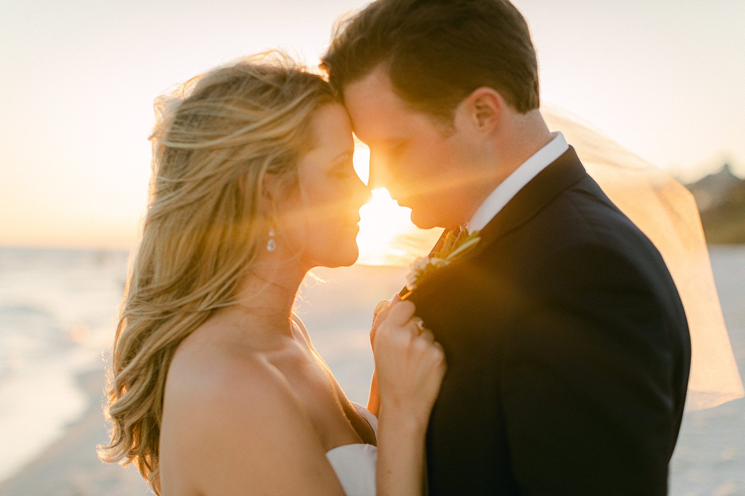 Bride and groom heads together on rosemary beach wedding day at the Pearl Hotel in Florida at sunset