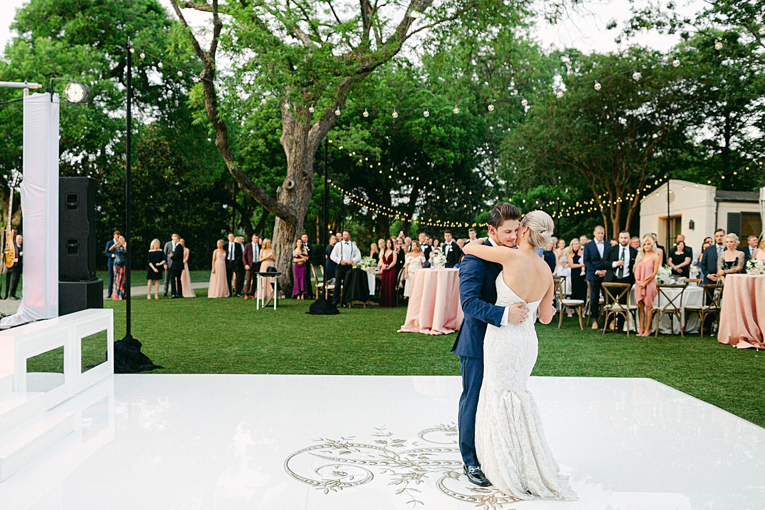 Bride and groom dancing on white outdoor dance floor Dallas Arboretum wedding garden reception