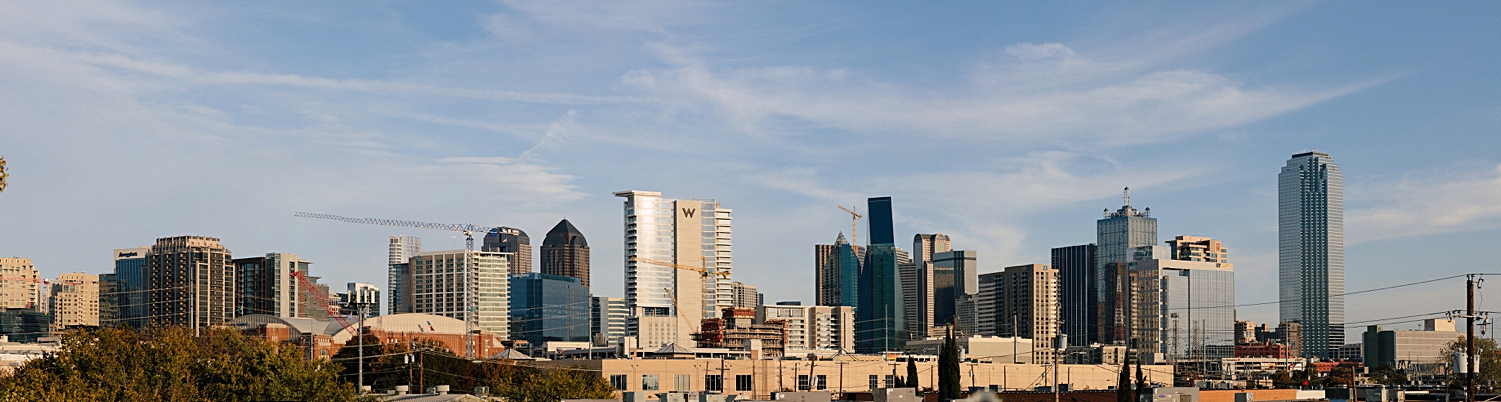 Dallas Texas skyline against blue sky skyscrapers